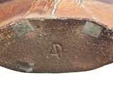 a close up of a piece of pottery with a bird on it