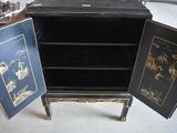a small cabinet with two doors open on the floor
