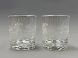 pair of etched glass tumblers with a horse and carriage design