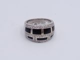 a close up of a ring on a white surface with diamonds