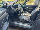 the interior of a car with the door open and the driver ' s seat down