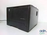a black printer sitting on a white table