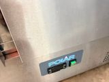 an image of a stainless steel oven with a blue sign on it