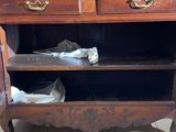 a wooden cabinet with two drawers on top of it