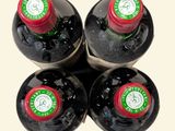 four bottles of wine are lined up on a table