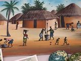 a picture of a painting of a village on the wall