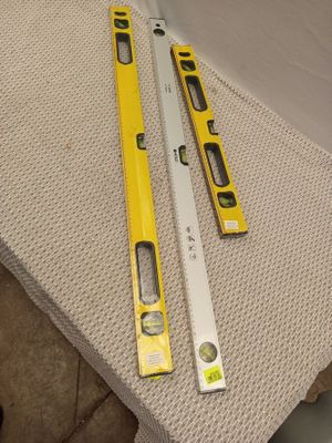 two tools that are laying on the floor