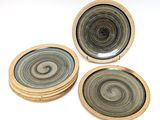 three coasters with a circular design on them sitting on a table