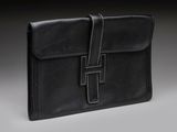 a black leather briefcase on a grey background