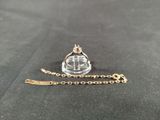 a close up of a necklace with a crown on it