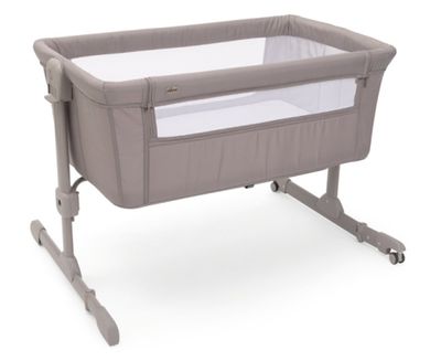 a baby crib with a baby bed attached to it ' s side