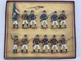 six figurines of men in uniform holding rifles and a flag