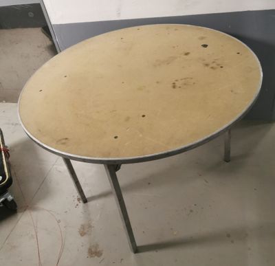 a small round table with a metal base in a room