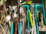 a drawer full of utensils and spoons in it