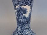 a blue and white vase sitting on a table