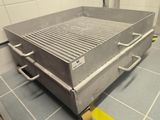 an image of a stainless steel grill on a tiled floor