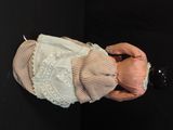 a doll that is holding a bottle in its hand
