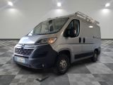 the silver van is parked on a checkered floor in a room