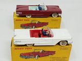 two toy cars that are sitting on top of each other