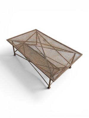 a metal coffee table with a mesh top on a white background