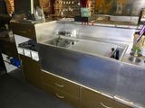 a sink in the middle of a counter in a kitchen
