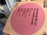 a pink sign on the back of a cardboard box