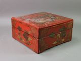 a small red box with a floral design on it