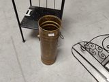 a metal shelf with a pot on it next to a bed