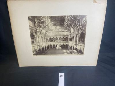 an old picture of a building with a clock on it