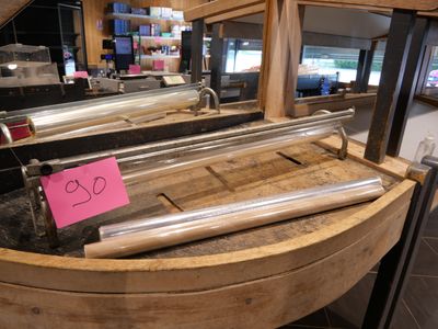 a wooden barrel with a sign on it in a store