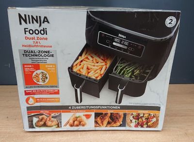 packaging of the ninja foodi dual zone is shown on a table