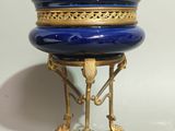 a blue and gold box sitting on top of a stand