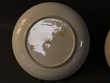 two white plates that are sitting next to each other
