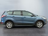 the 2017 ford escape is parked in a room with a gray wall