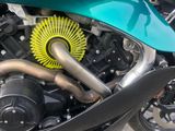 a close up of a motorcycle with a yellow exhaust pipe