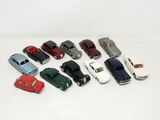 several toy cars are lined up in a row on a white surface