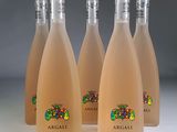 four bottles of wine are lined up on a table