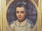 portrait of a young girl in a white dress with a blue bow