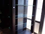 une vitrine en verre dans le coin d'une pièce