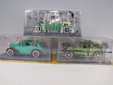 three toy cars that are sitting in a display case