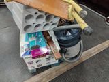 a vacuum that is on top of a pile of books