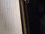 a close up of a black and white purse with a zipper