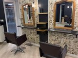 two chairs in a room with mirrors on the wall