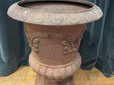 a large vase that is sitting on a wooden stand