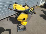 a small yellow machine that is sitting on the ground
