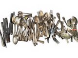 a lot of spoons and forks on the table