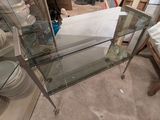 a glass table with a glass shelf on top of it