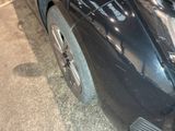 a close up of a car ' s front bumper and fender