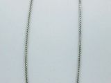a close up of a necklace on a white surface