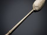 a silver spoon with a design on the handle
